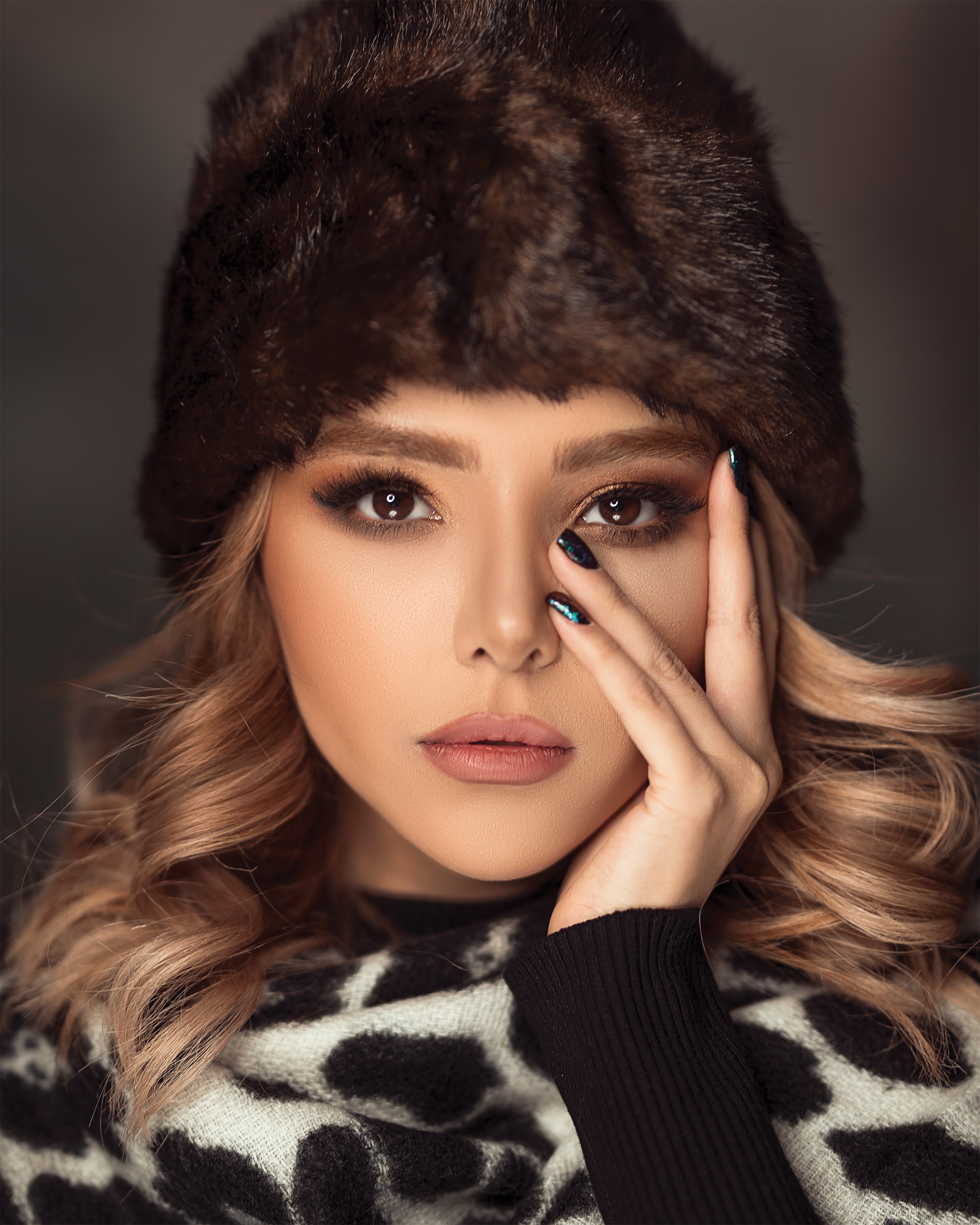 studio portrait with a woman wearing a beanie